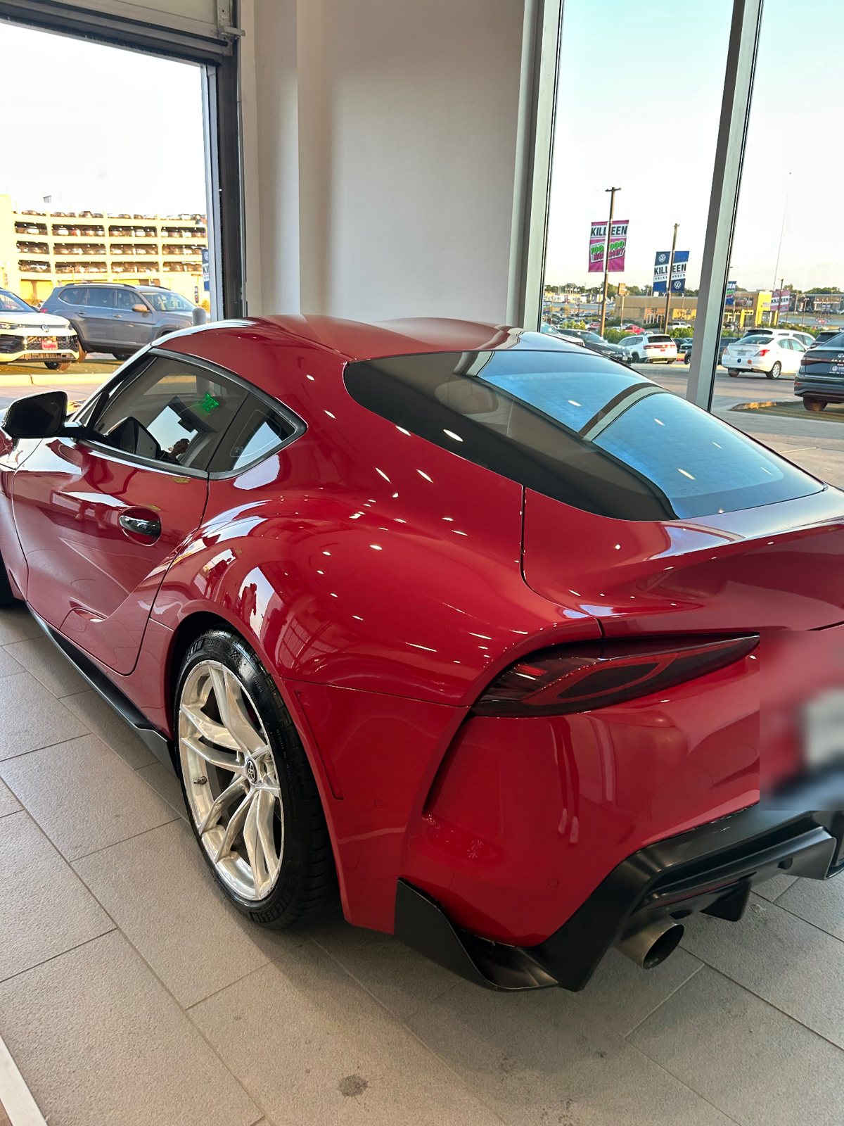 Rear three-quarter of the red Toyota GR Supra